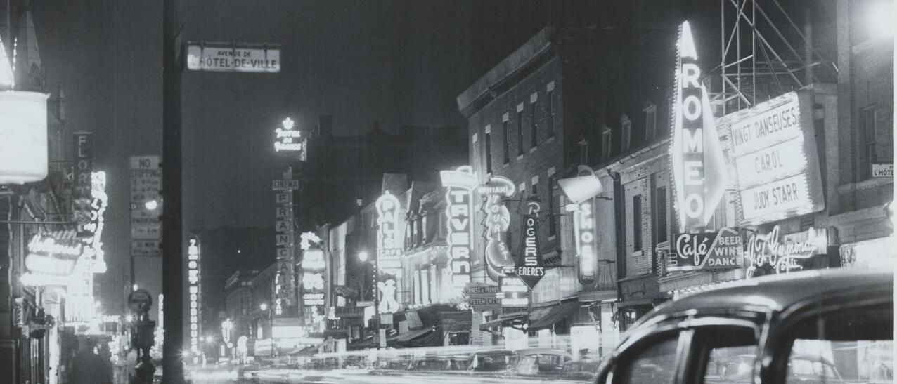 Vue sur la rue Sainte-Catherine la nuit avec ses enseignes illuminées